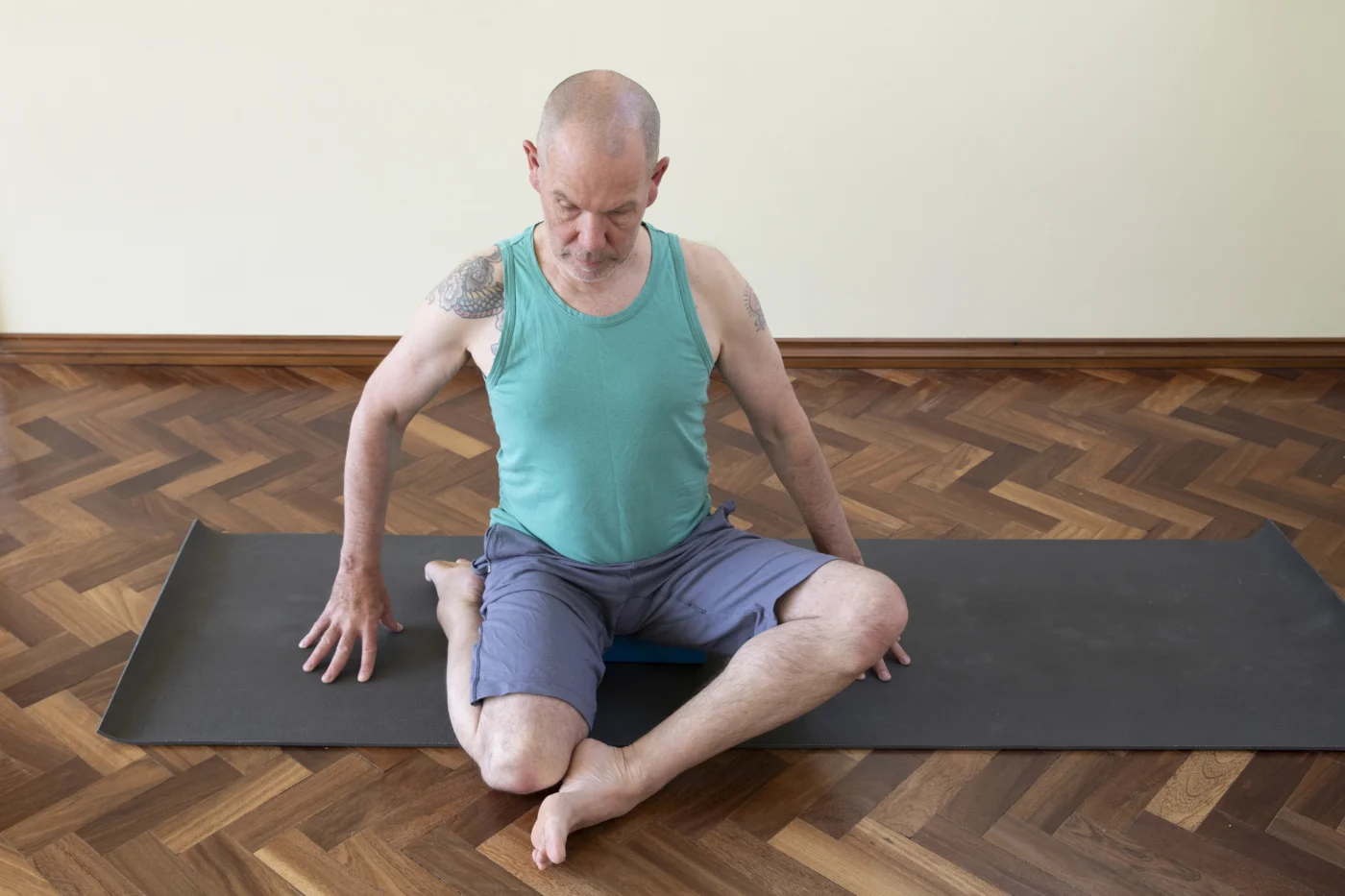 Norman Blair seated in deer pose on a mat